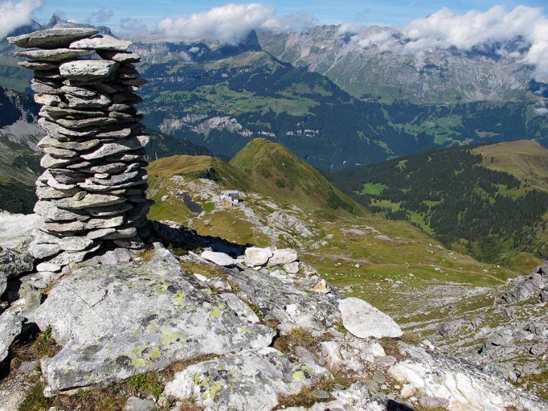Kräftiger Steinmann und bereits tiefer unten Leglerhütte